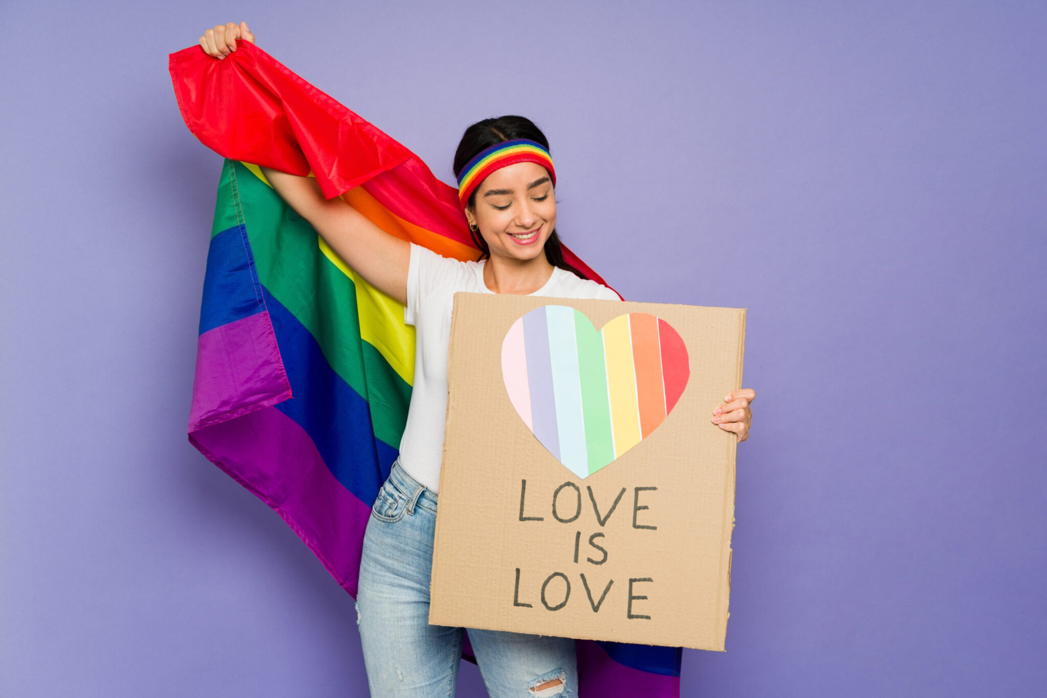 Love is love. Cheerful queer woman holding a message supporting the LGBT community during a march